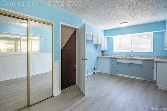 36426 Weideman St, Clinton Township, MI 48035 - kitchen with a textured ceiling, light wood-type flooring, and light countertops