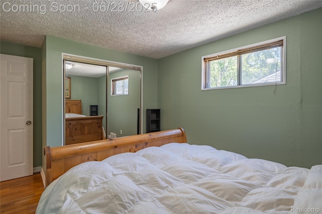 36426 Weideman St, Clinton Township, MI 48035 - bedroom featuring wood finished floors, a textured ceiling, and a closet