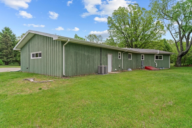 7060 Dobson Rd, Jonesville, MI 49250 - back of property with central AC, a yard, and board and batten siding