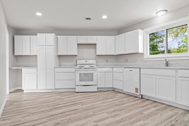 7060 Dobson Rd, Jonesville, MI 49250 - kitchen featuring white appliances, a sink, white cabinets, recessed lighting, and light wood-type flooring