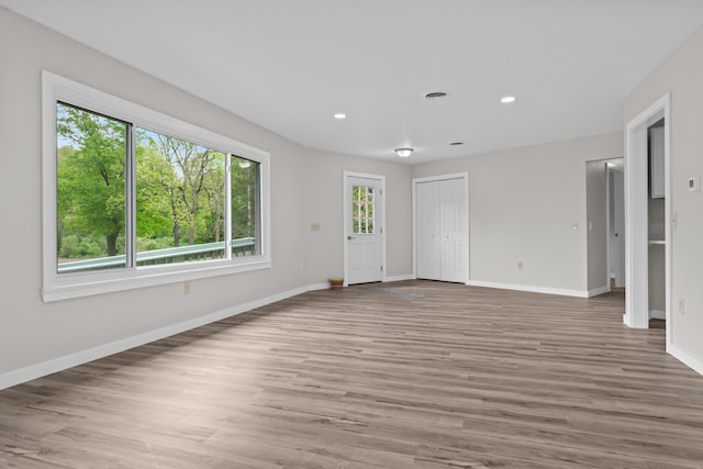 7060 Dobson Rd, Jonesville, MI 49250 - unfurnished room featuring baseboards, light wood-style floors, and recessed lighting