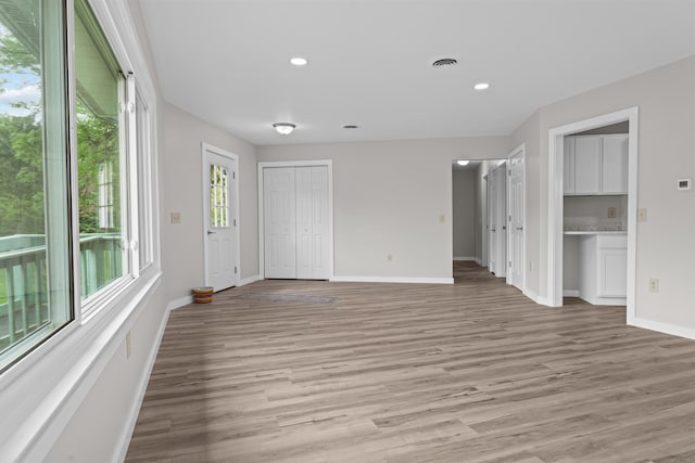 7060 Dobson Rd, Jonesville, MI 49250 - empty room featuring light wood-style floors, baseboards, and recessed lighting