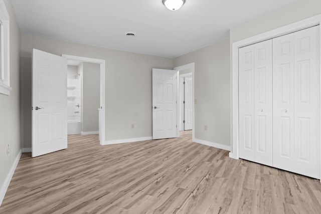 7060 Dobson Rd, Jonesville, MI 49250 - unfurnished bedroom featuring light wood-type flooring, baseboards, and a closet