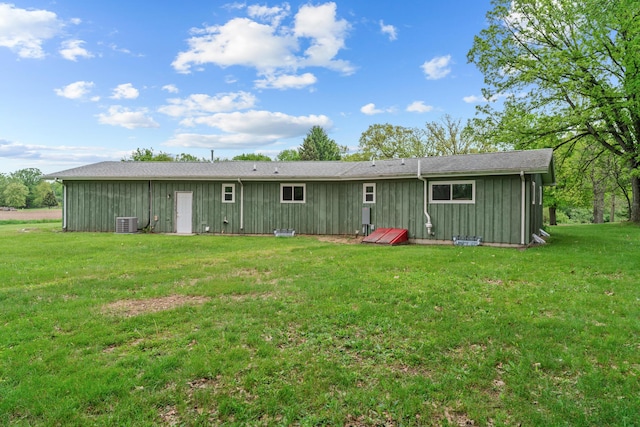7060 Dobson Rd, Jonesville, MI 49250 - back of property featuring a yard, board and batten siding, and cooling unit