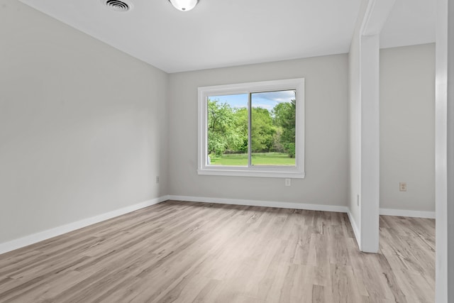 7060 Dobson Rd, Jonesville, MI 49250 - spare room featuring light wood-style flooring and baseboards