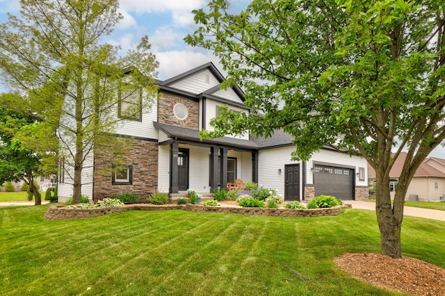 8460 Woodridge Dr, Davison, MI 48423 - craftsman-style house with stone siding, driveway, a front lawn, covered porch, and a garage