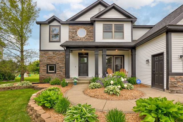 8460 Woodridge Dr, Davison, MI 48423 - view of front of house with stone siding, covered porch, and a front yard