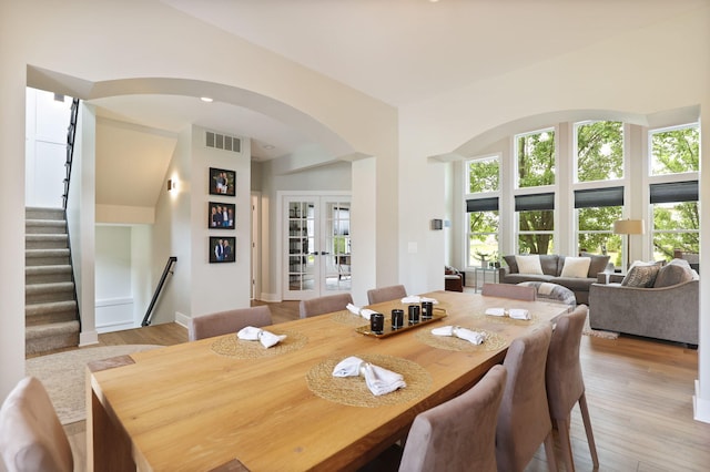 8460 Woodridge Dr, Davison, MI 48423 - dining room featuring arched walkways, healthy amount of natural light, and light wood-style flooring