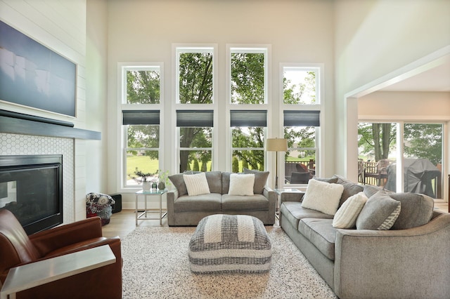 8460 Woodridge Dr, Davison, MI 48423 - living room with a fireplace, plenty of natural light, wood finished floors, and a towering ceiling