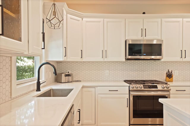 8460 Woodridge Dr, Davison, MI 48423 - kitchen with appliances with stainless steel finishes, white cabinetry, tasteful backsplash, and glass insert cabinets