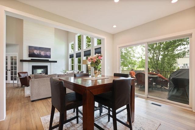 8460 Woodridge Dr, Davison, MI 48423 - dining space featuring healthy amount of natural light, a large fireplace, light wood-style floors, and recessed lighting