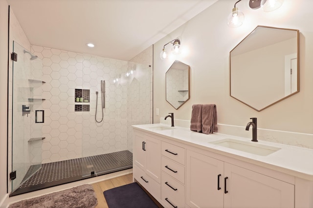 8460 Woodridge Dr, Davison, MI 48423 - bathroom featuring double vanity, a stall shower, wood finished floors, and recessed lighting