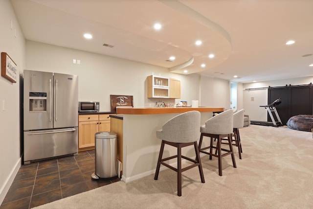 8460 Woodridge Dr, Davison, MI 48423 - kitchen featuring appliances with stainless steel finishes, light brown cabinets, a breakfast bar area, recessed lighting, and a barn door