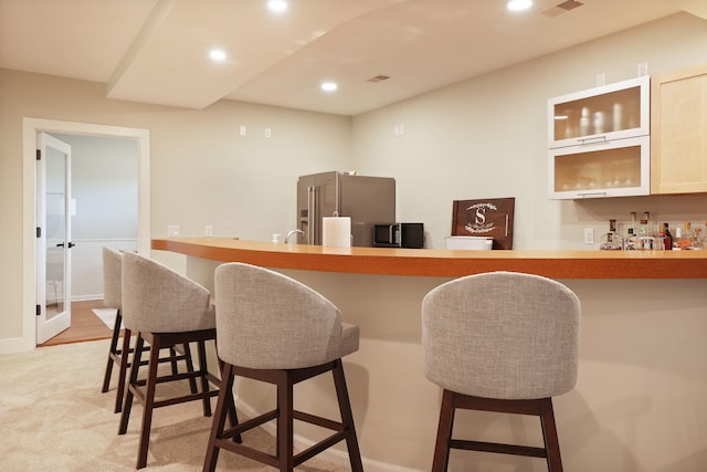 8460 Woodridge Dr, Davison, MI 48423 - indoor wet bar with high end refrigerator, recessed lighting, and black microwave