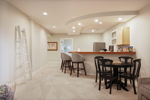 8460 Woodridge Dr, Davison, MI 48423 - dining area featuring light carpet, recessed lighting, and bar