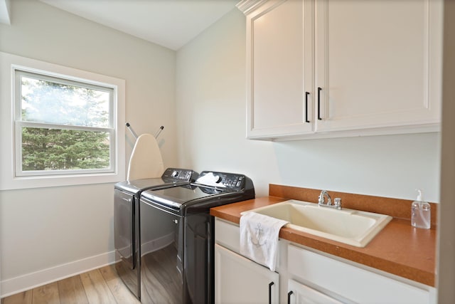 8460 Woodridge Dr, Davison, MI 48423 - washroom featuring cabinet space, washing machine and dryer, and light wood-style flooring