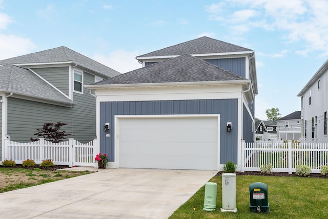 245 Cavelier Ave, Saint Joseph, MI 49085 - traditional-style house featuring roof with shingles, a garage, and concrete driveway