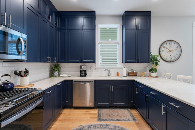 245 Cavelier Ave, Saint Joseph, MI 49085 - kitchen with stainless steel appliances, a sink, tasteful backsplash, and light wood finished floors