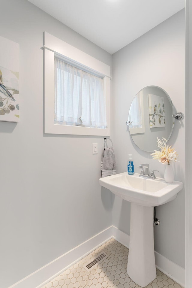 245 Cavelier Ave, Saint Joseph, MI 49085 - bathroom featuring baseboards and a sink