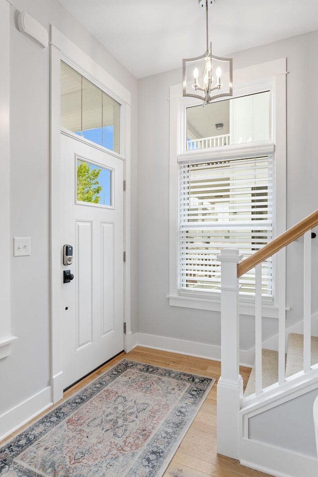 245 Cavelier Ave, Saint Joseph, MI 49085 - foyer with a chandelier, wood finished floors, baseboards, and stairway