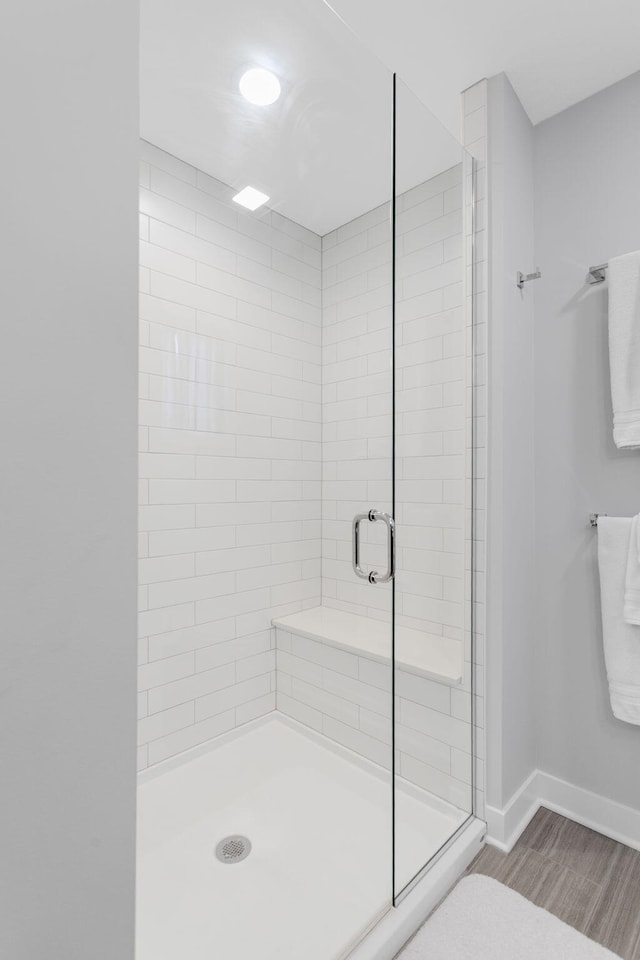 245 Cavelier Ave, Saint Joseph, MI 49085 - bathroom featuring a shower stall, baseboards, and wood finished floors