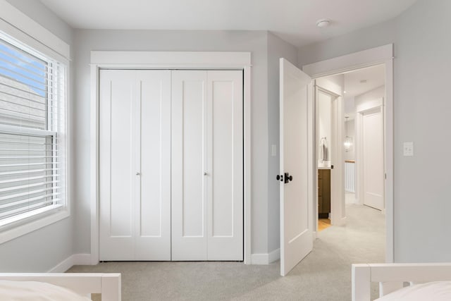 245 Cavelier Ave, Saint Joseph, MI 49085 - bedroom featuring light carpet, baseboards, and a closet