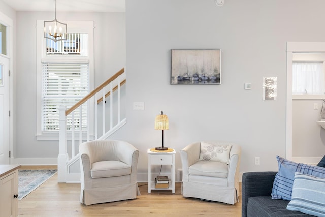 245 Cavelier Ave, Saint Joseph, MI 49085 - living room featuring a chandelier, light wood-style floors, stairs, and baseboards