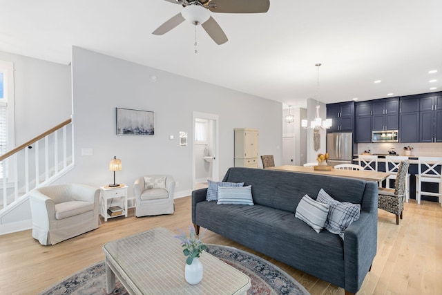 245 Cavelier Ave, Saint Joseph, MI 49085 - living area with a chandelier, light wood-style floors, a ceiling fan, stairs, and recessed lighting