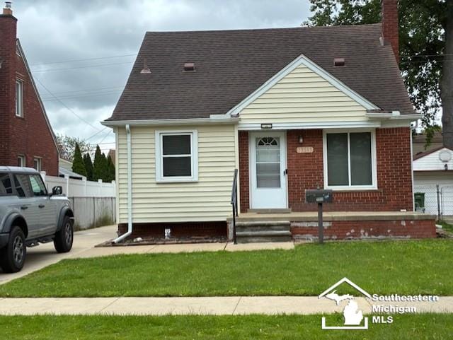 13535 Netherwood St, Southgate, MI 48195 - view of front of home with a chimney, roof with shingles, and brick siding