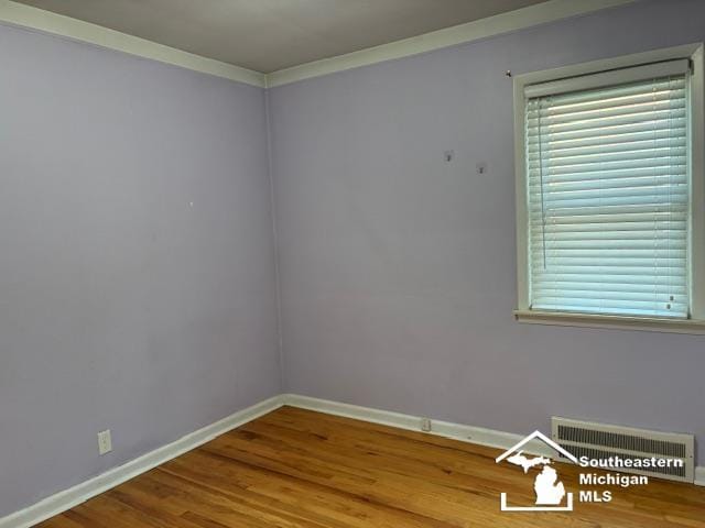 13535 Netherwood St, Southgate, MI 48195 - spare room with baseboards, wood finished floors, and ornamental molding
