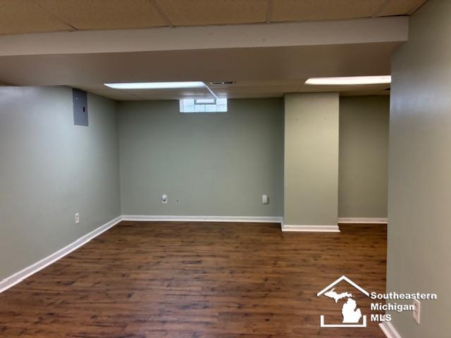 13535 Netherwood St, Southgate, MI 48195 - below grade area featuring wood finished floors, a paneled ceiling, and baseboards