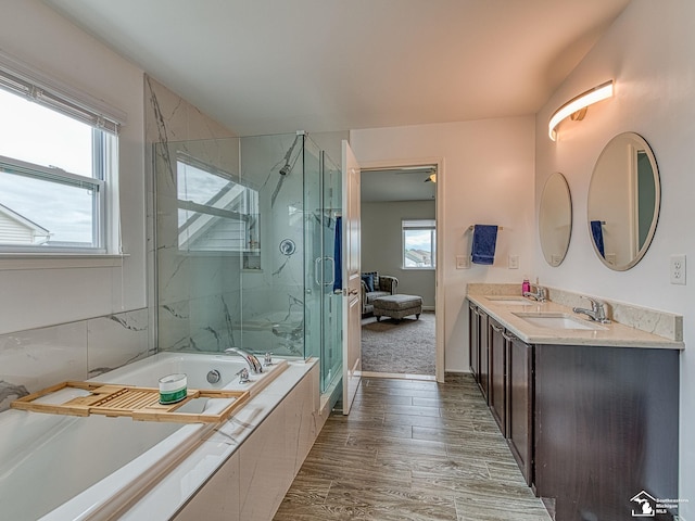 691 Foxworth St, Dundee, MI 48131 - full bath with a garden tub, a marble finish shower, double vanity, and wood finished floors