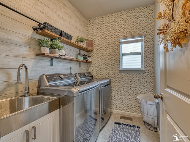 691 Foxworth St, Dundee, MI 48131 - laundry area with washing machine and clothes dryer, wallpapered walls, light tile patterned flooring, cabinet space, and baseboards