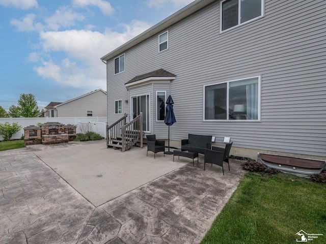 691 Foxworth St, Dundee, MI 48131 - rear view of house with a patio area and an outdoor living space