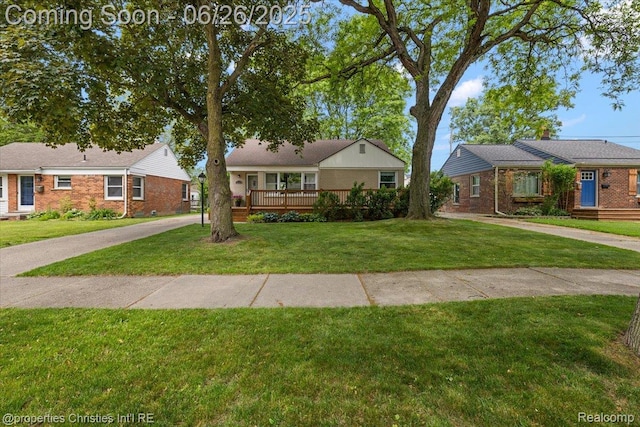 2111 Ellwood Ave, Berkley, MI 48072 - view of front facade featuring a front yard, brick siding, and a deck