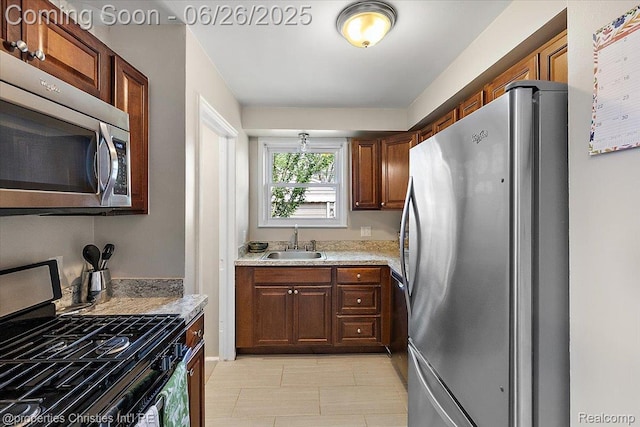 2111 Ellwood Ave, Berkley, MI 48072 - kitchen featuring stainless steel appliances, light countertops, and light tile patterned floors