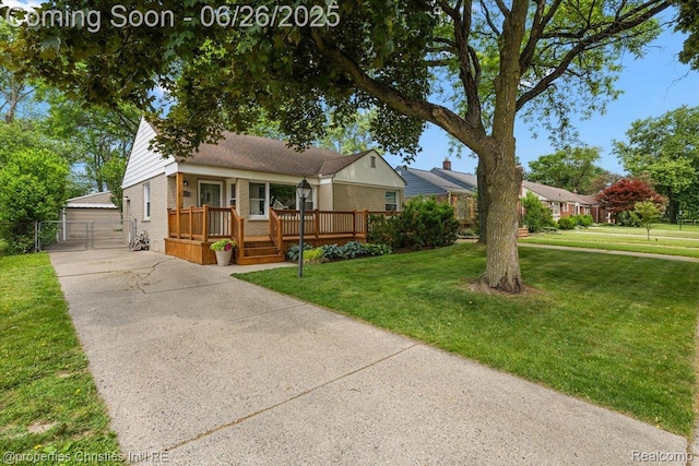2111 Ellwood Ave, Berkley, MI 48072 - view of front facade with brick siding, a gate, a detached garage, and a deck