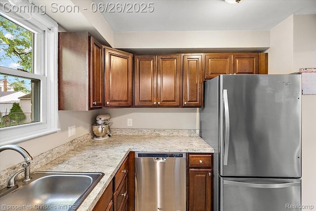 2111 Ellwood Ave, Berkley, MI 48072 - kitchen with appliances with stainless steel finishes, light countertops, and brown cabinetry