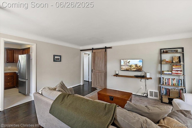 2111 Ellwood Ave, Berkley, MI 48072 - living area featuring a barn door, ornamental molding, and wood finished floors