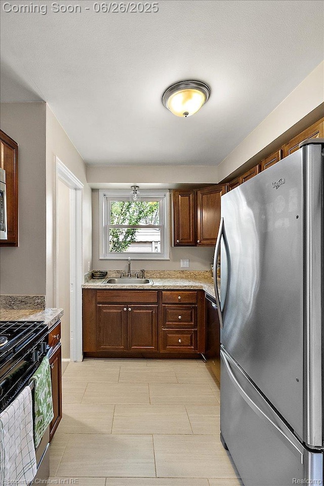 2111 Ellwood Ave, Berkley, MI 48072 - kitchen with appliances with stainless steel finishes, light countertops, and dark brown cabinets