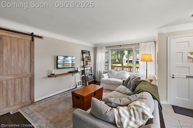 2111 Ellwood Ave, Berkley, MI 48072 - living area with wood finished floors, crown molding, and a barn door