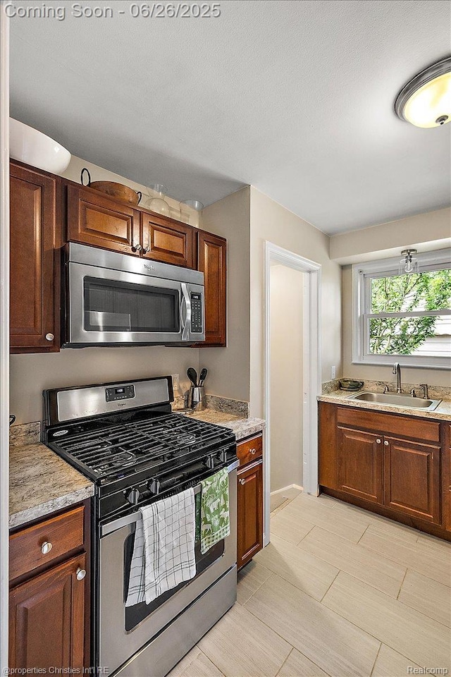2111 Ellwood Ave, Berkley, MI 48072 - kitchen featuring stainless steel appliances and brown cabinetry