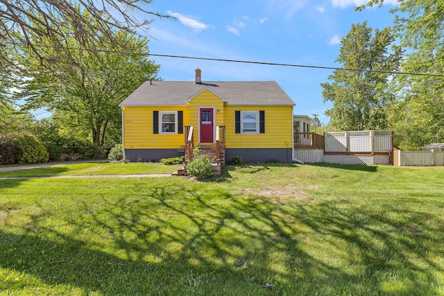 17270 Taft Rd, Spring Lake, MI 49456 - bungalow-style home with a chimney, a wooden deck, and a front yard