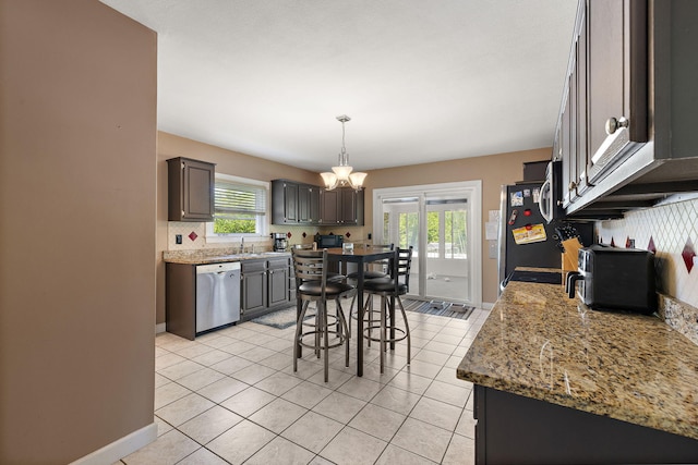 17270 Taft Rd, Spring Lake, MI 49456 - kitchen featuring stainless steel appliances, a chandelier, healthy amount of natural light, and light tile patterned floors
