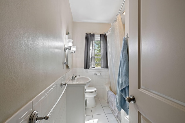 17270 Taft Rd, Spring Lake, MI 49456 - full bathroom with tile patterned floors, toilet, vanity, tile walls, and wainscoting