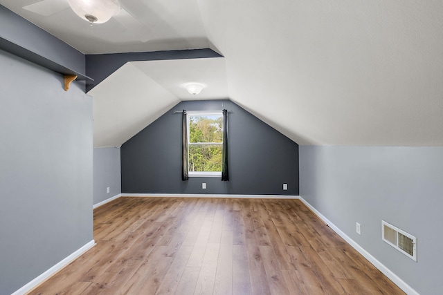 17270 Taft Rd, Spring Lake, MI 49456 - additional living space with wood finished floors, lofted ceiling, and baseboards