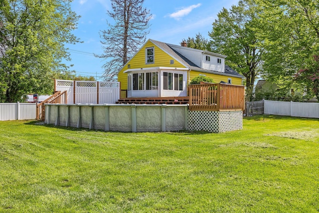 17270 Taft Rd, Spring Lake, MI 49456 - rear view of house featuring a wooden deck, a shingled roof, and a sunroom