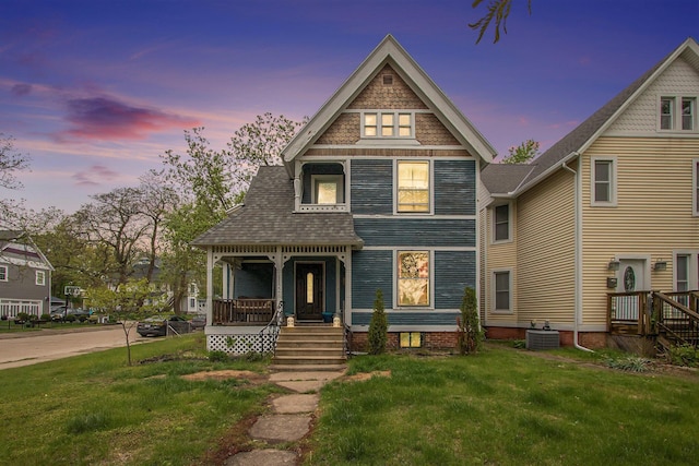 1122 Main St, Saint Joseph, MI 49085 - victorian-style house featuring a porch, central AC, and a front yard