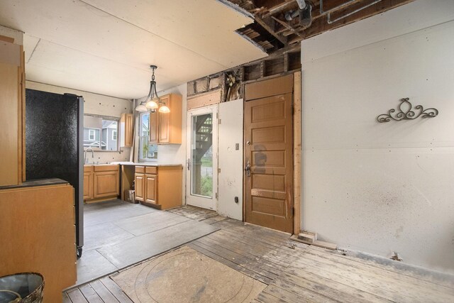 1122 Main St, Saint Joseph, MI 49085 - kitchen with decorative light fixtures, light wood-type flooring, and light countertops