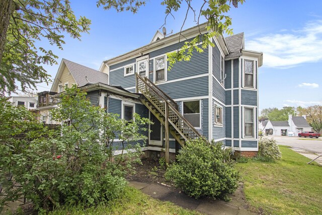1122 Main St, Saint Joseph, MI 49085 - rear view of property featuring stairs and a yard